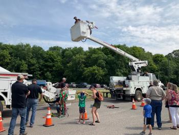 Kids had a chance to experience a day in the life of a co-op lineworker, trying on safety gear and riding in a bucket truck high above the event at Polk-Burnett Electric Cooperative in Centuria.