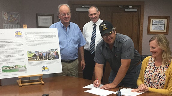 Co-op and fire association sign loan papers 
